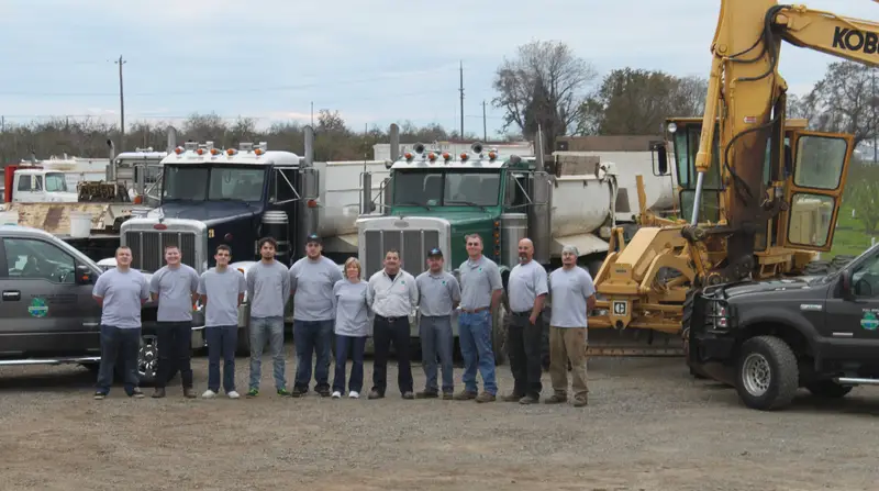 The Alliance Environmental crew with trucks and equipment at the yard